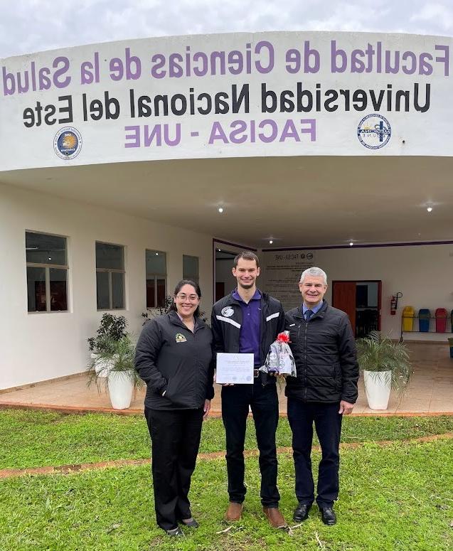 Professor Joseph LaForge stands next to staff of Paraguay's only national medical university.